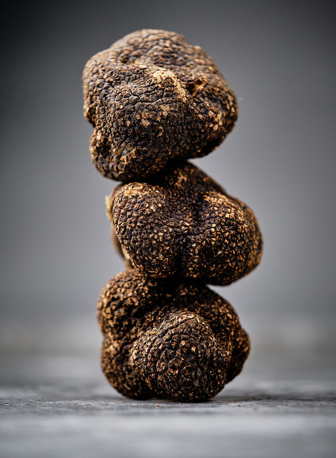 Stack of truffles on a gray background
