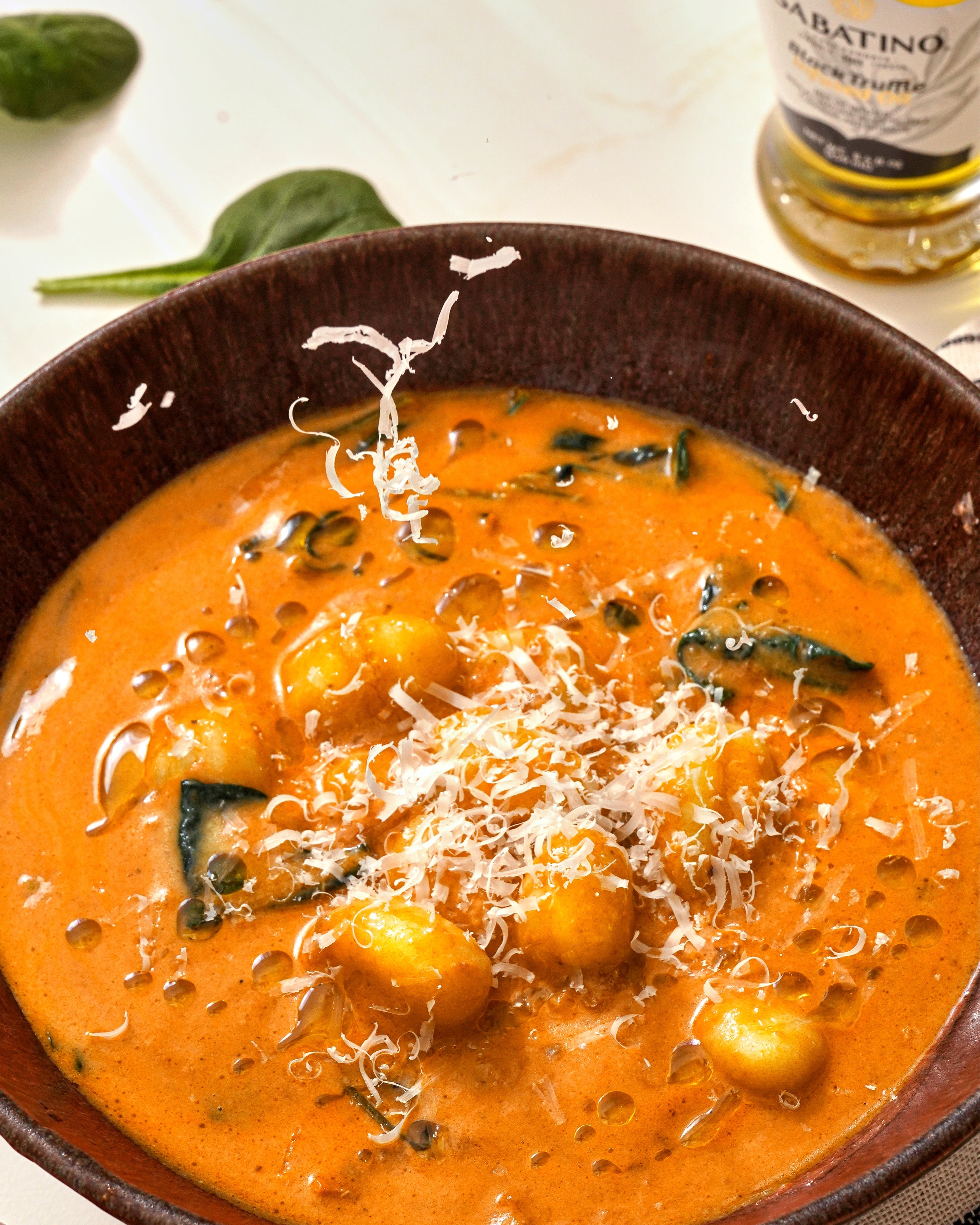 a bowl of soup with cheese and spinach