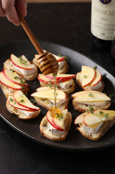 Crostini with brie, fresh apple slices, and truffle honey
