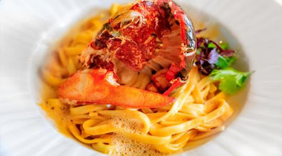 GRILLED LOBSTER TAILS FRA DIABLO SERVED WITH FETTUCCINE AND SABATINO WHITE TRUFFLES