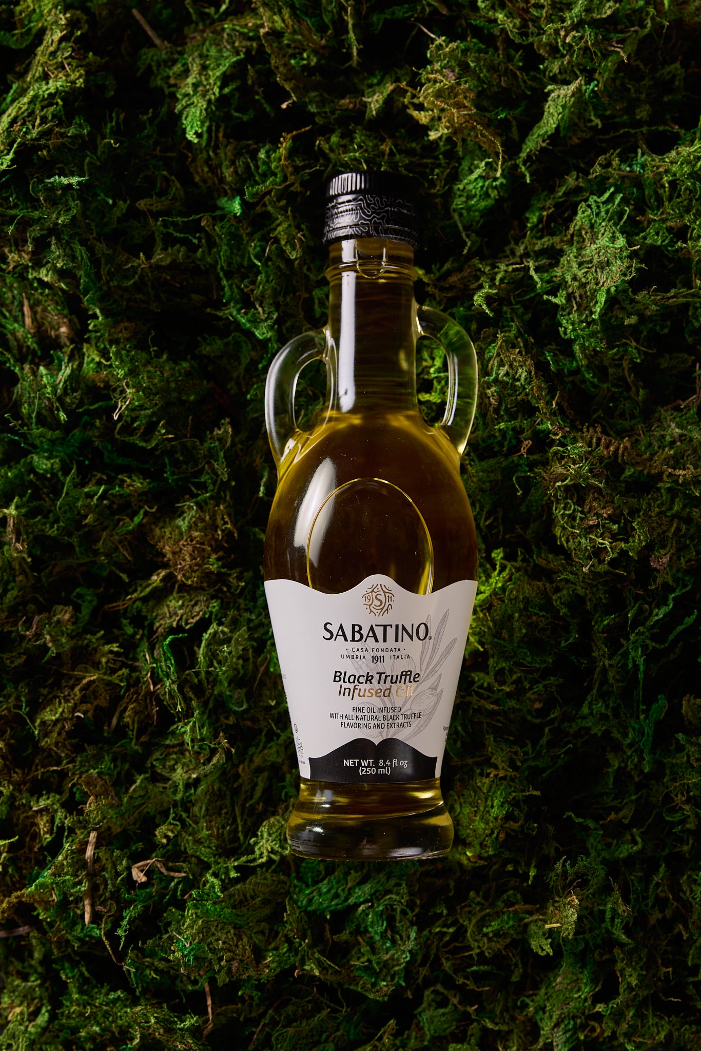 a bottle of oil on grass
