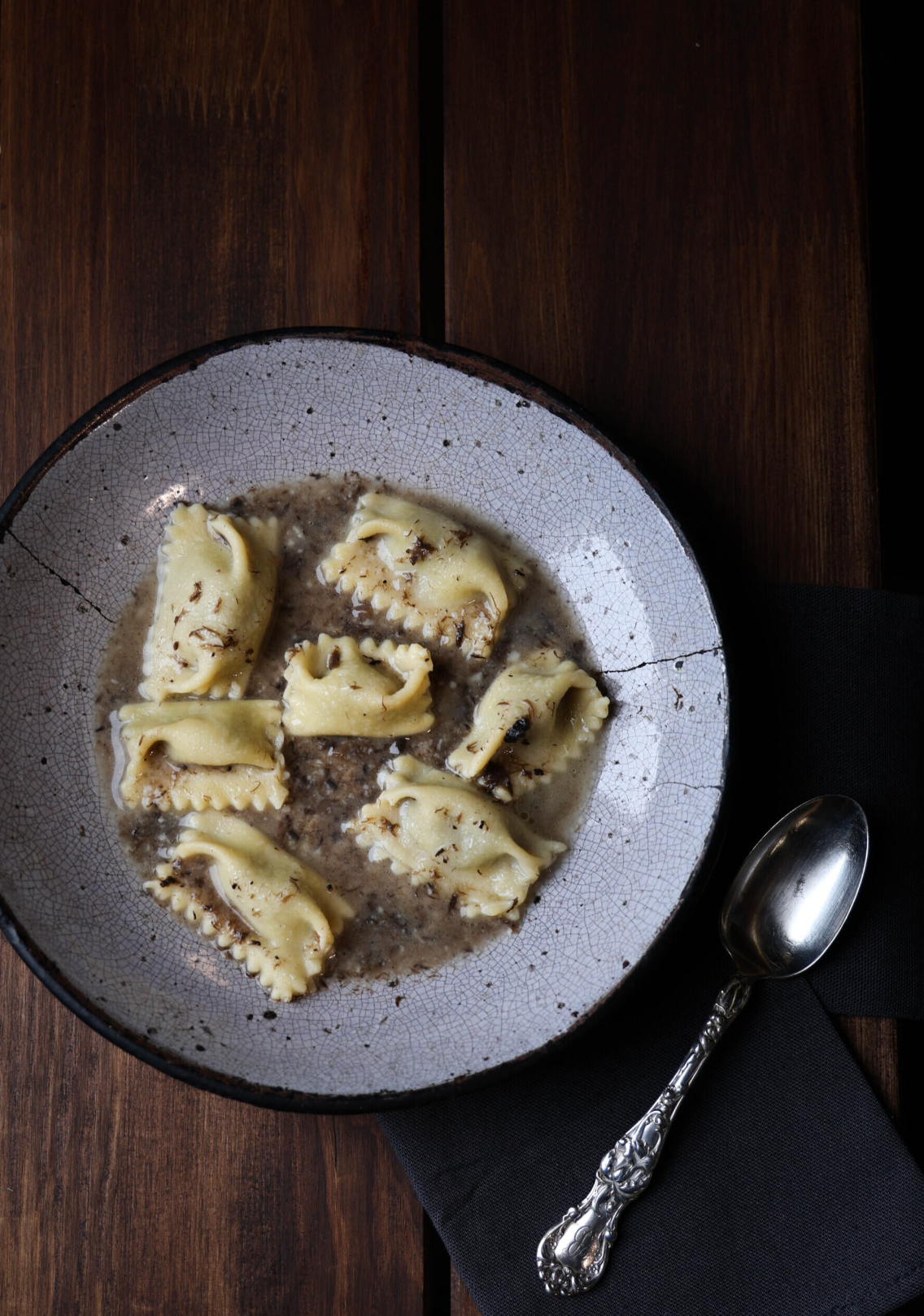 a bowl of pasta with sauce and spoon